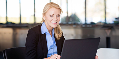 A businesswoman attending a meeting on a laptop